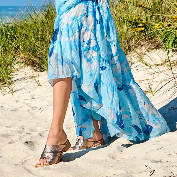 Woman standing on beach wearing a blue dress featuring the the Fallon heel in metallic. Shop Ballerina flats, Dress flats, Flat sandals.